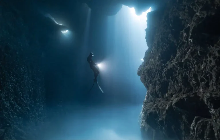 A first-time diver exploring underwater at the try dive maximum depth under instructor supervision.