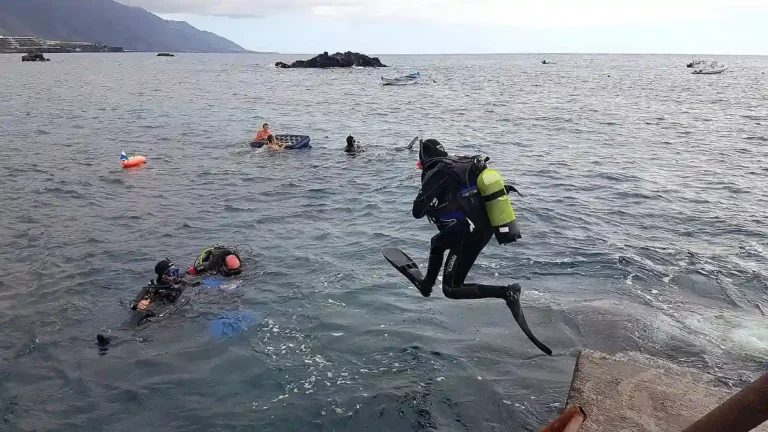 Diver jumping into the water to begin a scuba diving experience in La Palma