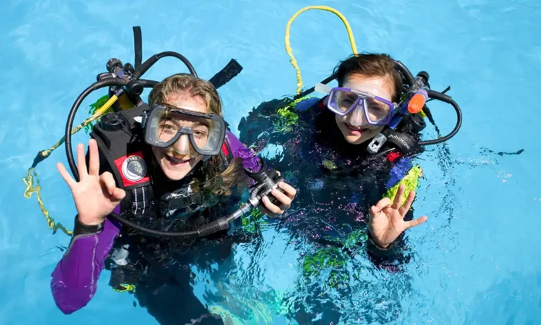 Two female divers making the OK sign before a scuba diving experience in Lanzarote
