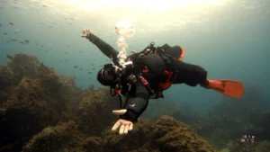 Diver opening their arms happily during a scuba dive in Costa Teguise, Lanzarote