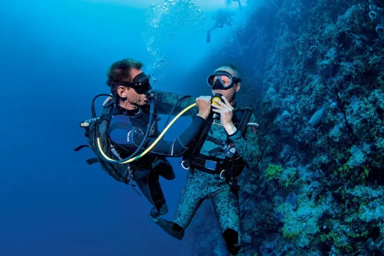 Buceadores practicando el uso del regulador de emergencia bajo el agua