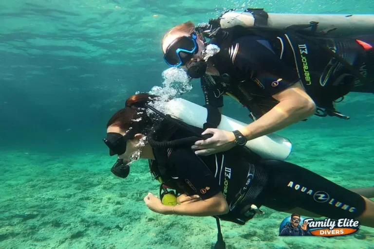Instructor guiding a female diver during a scuba diving experience in Spain