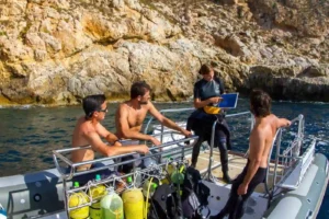 Divers receiving a boat briefing before a scuba training dive