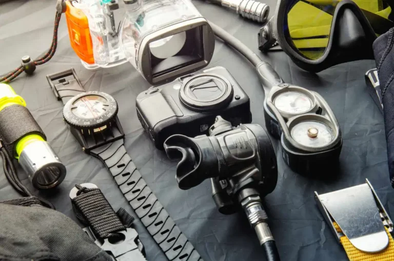 Different pieces of diving equipment laid out on a table before a scuba dive